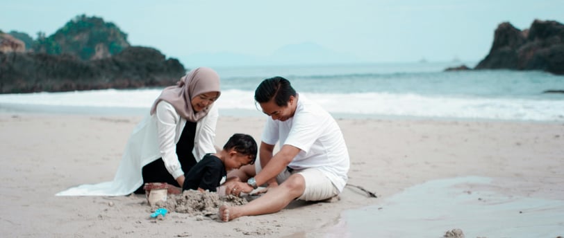 sebuah keluarga hangat bermain pasir pantai