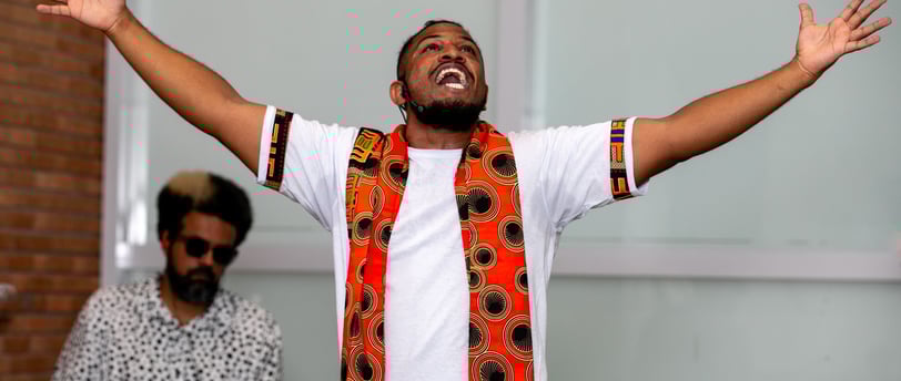 a man with a beard and a tie dye on his shirt
