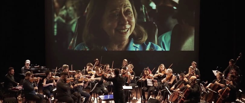 a conductor and orchestra in a concert