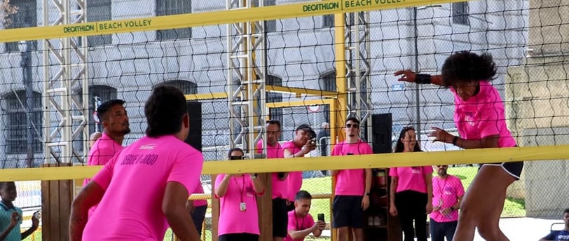 a group of people playing volleyball in a stadium