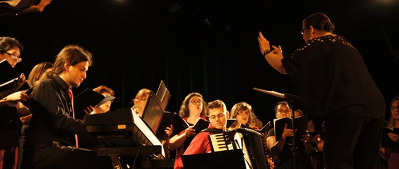 a bandleader playing a musical instrument in a concert