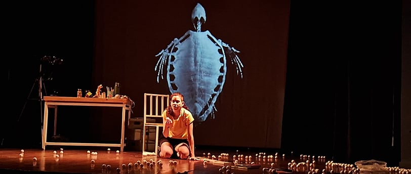 a woman sitting on a stage with candles and candles