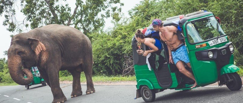 a man riding a tuk tuk tuk tuk tuk with a