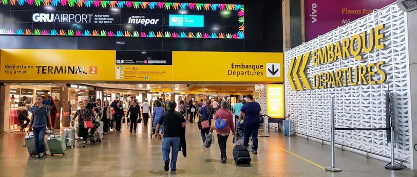 a group of people walking through a busy airport