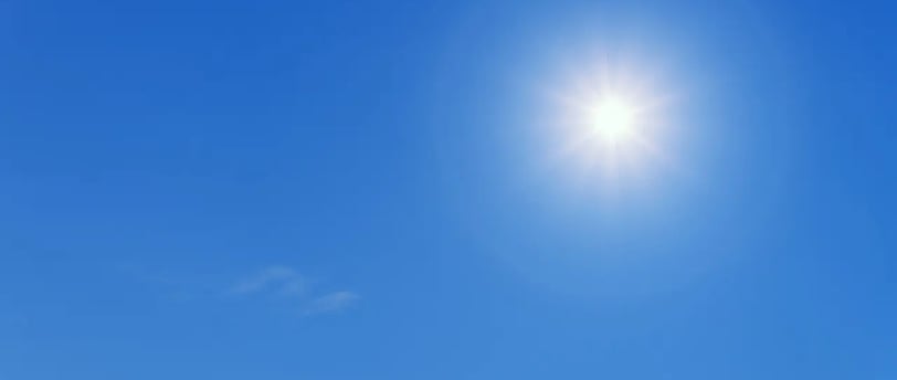 Soleil éclatant dans un ciel bleu dégagé, typique d’un balcon en plein soleil l’été.