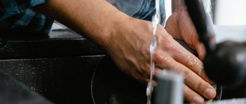a man is washing his hands in a sink