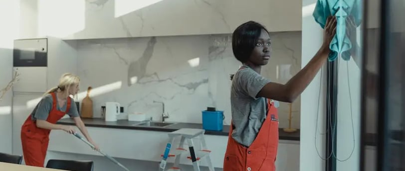 a woman cleaning a refrigerator door