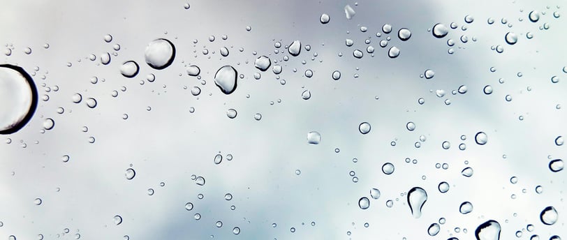 a close up of a rain soaked window with raindrops