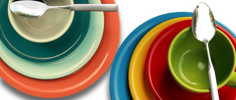 Different sized plates, two cups in orange, light green, green, blue, yellow, and red colors spoons