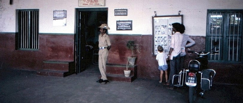 A police man standing in front of Police Station