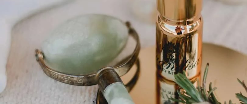 a bottle of liquid in a gold toned and a bottle of liquid