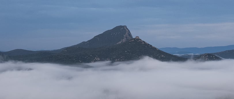 a mountain view of a mountain range with a few clouds