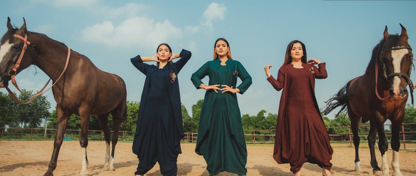 Female models wearing Kazaro tunics in a stud farm