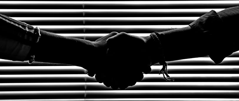 two friends holding hands in trust