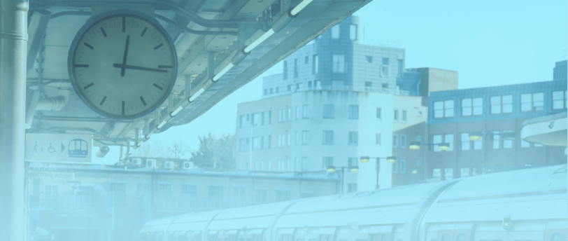 image of a clock on a train podium surrounded by fog