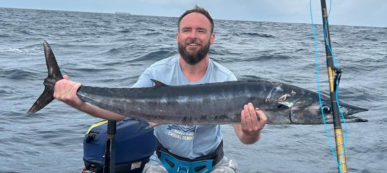 Angler holding a Wahoo in Zanzibar waters