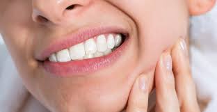 woman experiencing tooth sensitivity after filling