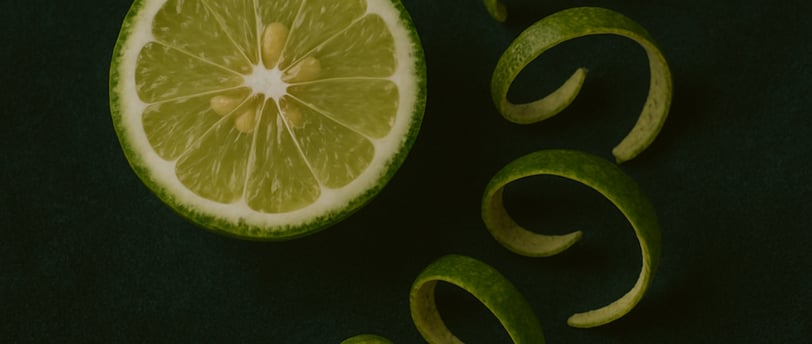 a slice of bergamot with a spiraling of bergamots on a green background