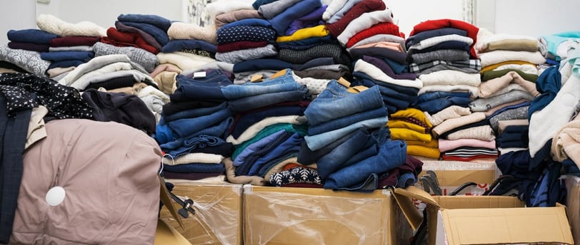a pile of clothes and boxes of clothes