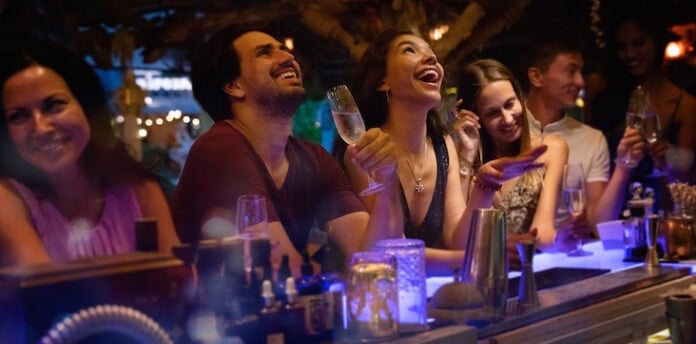 a group of people sitting at a bar