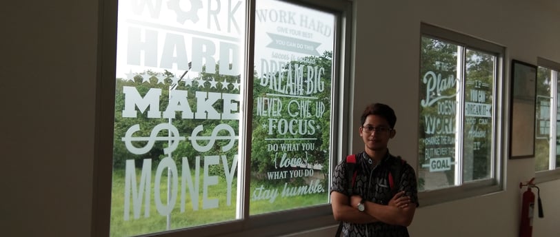 a man standing in front of a window with a window