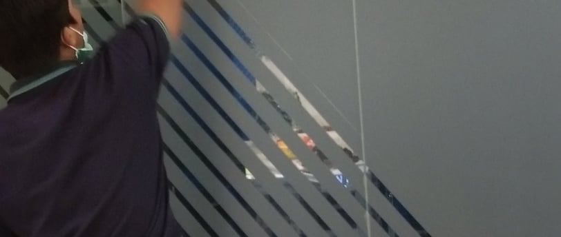 a man standing in a room with a glass door