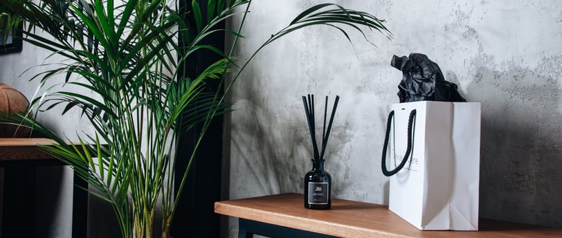black fragrance diffuser and white back with tree