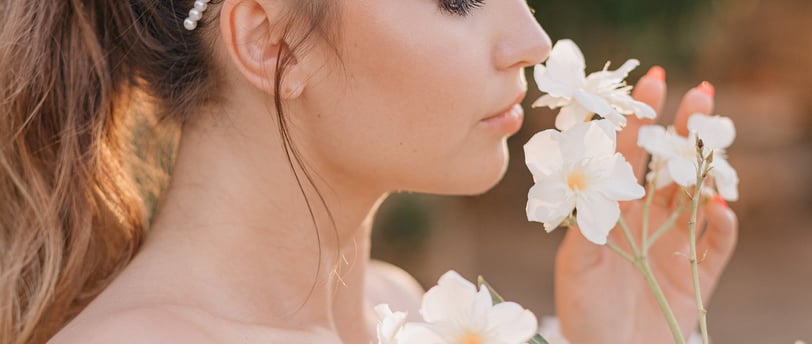 a woman with a smelling flowers