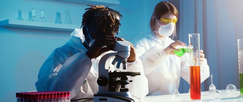 a woman in a lab coat and a microscope