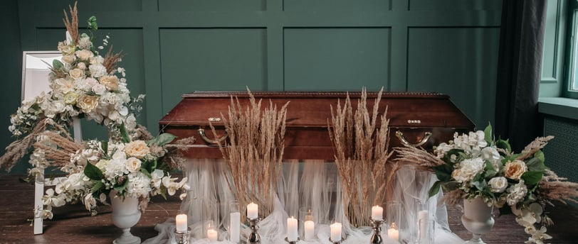 a funeral service with candles and flowers