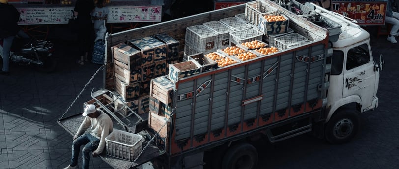 a man is pushing a carton of orange juice