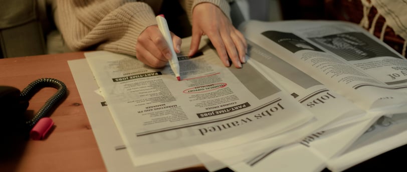 a person sitting at a table with a pen and a pen