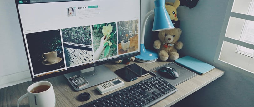 a computer on the table with the website design in the screen