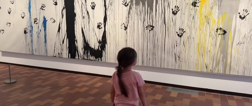 a young girl is walking through a museum