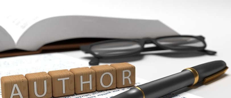 Wooden cubes, each with a letter that spells "AUTHOR"