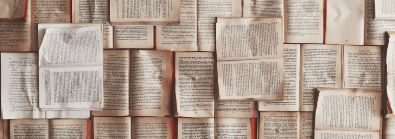 Pile of old used books open to read