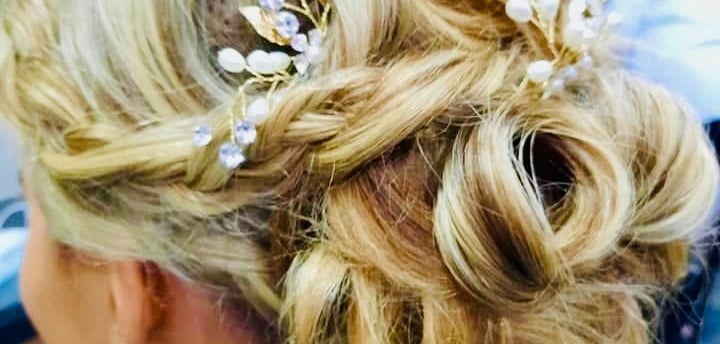 Bridal updo with pearl hairpiece by Salon Rene wedding stylist