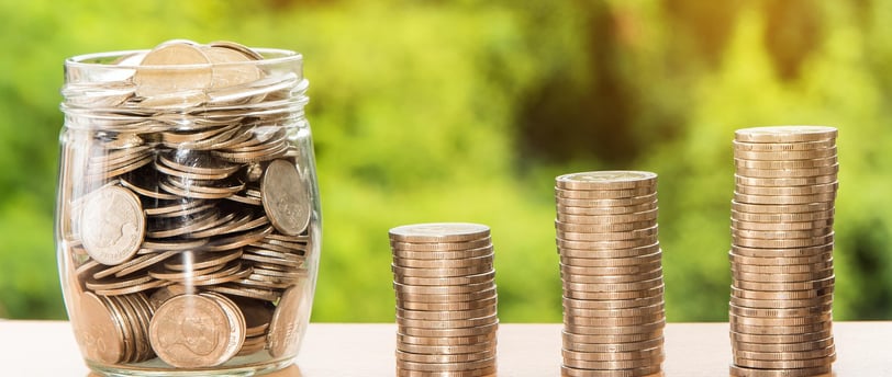 coins in a jar and in stacks consecutively growing larger