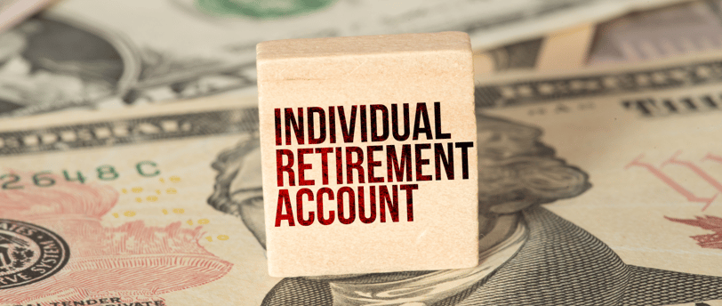 individual retirement account label on a block with money in the background