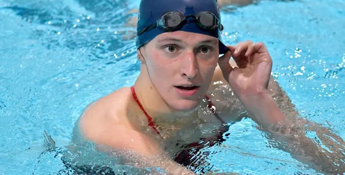 a man in a swimming cap and goggles in a swimming pool