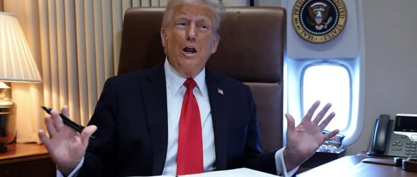 a man in a suit and tie is sitting at a desk