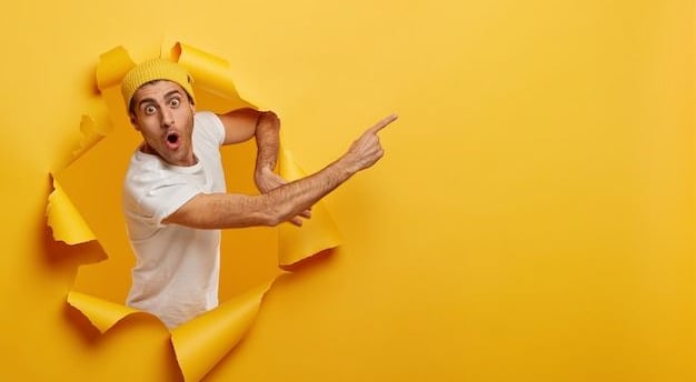 a man with a hat and a hat on his head is looking through a hole