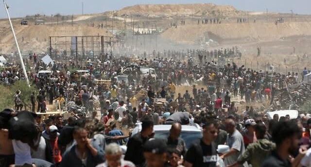 a closed border crossing with aid trucks stalled