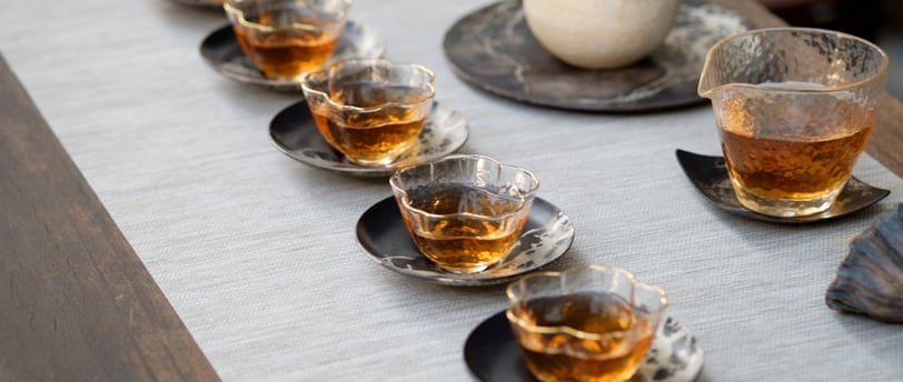 a table with tea cups and tea cups