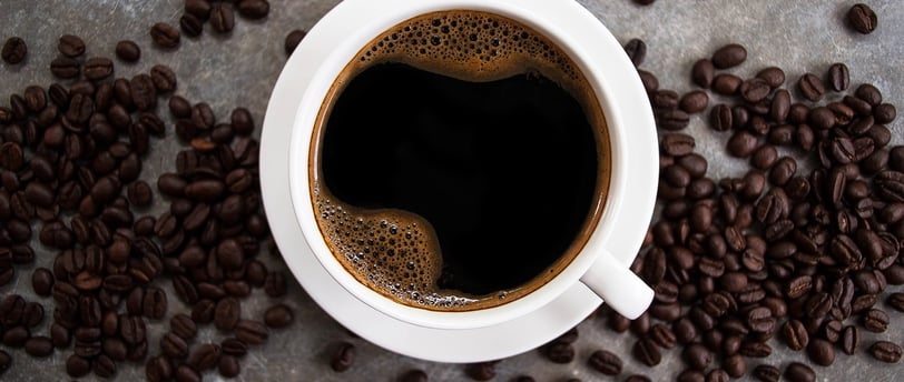 Cup of coffee with coffee beans