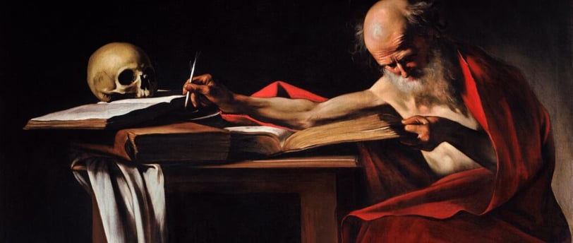 a man sitting at a table with a skull head