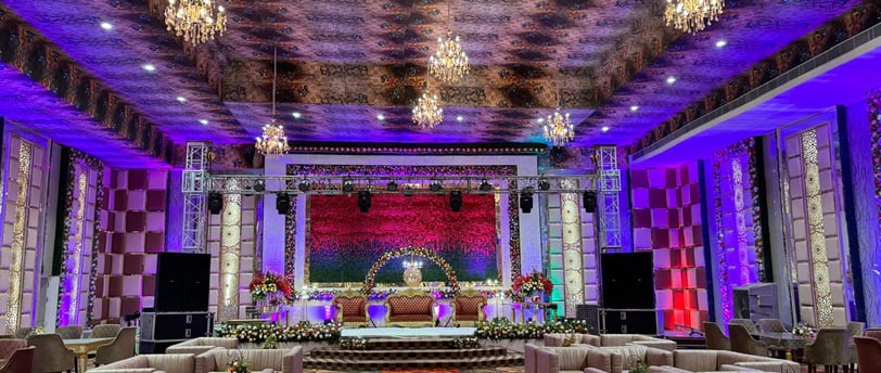 a large room with a stage set up for a wedding