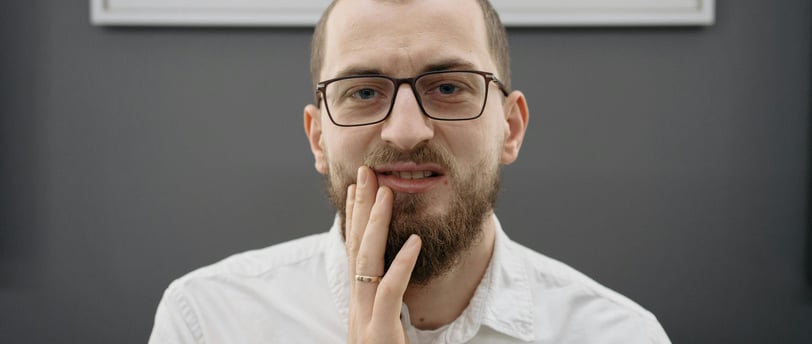 a man with a beard and glasses on his face