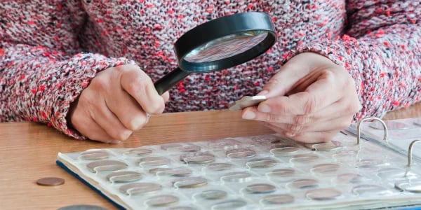 Grading Coin Viewing With Magnifying Glass