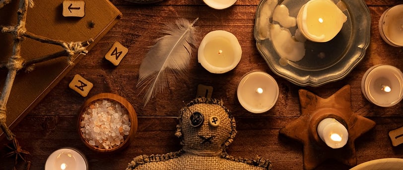 a teddy bear sitting on a table with candles and candles